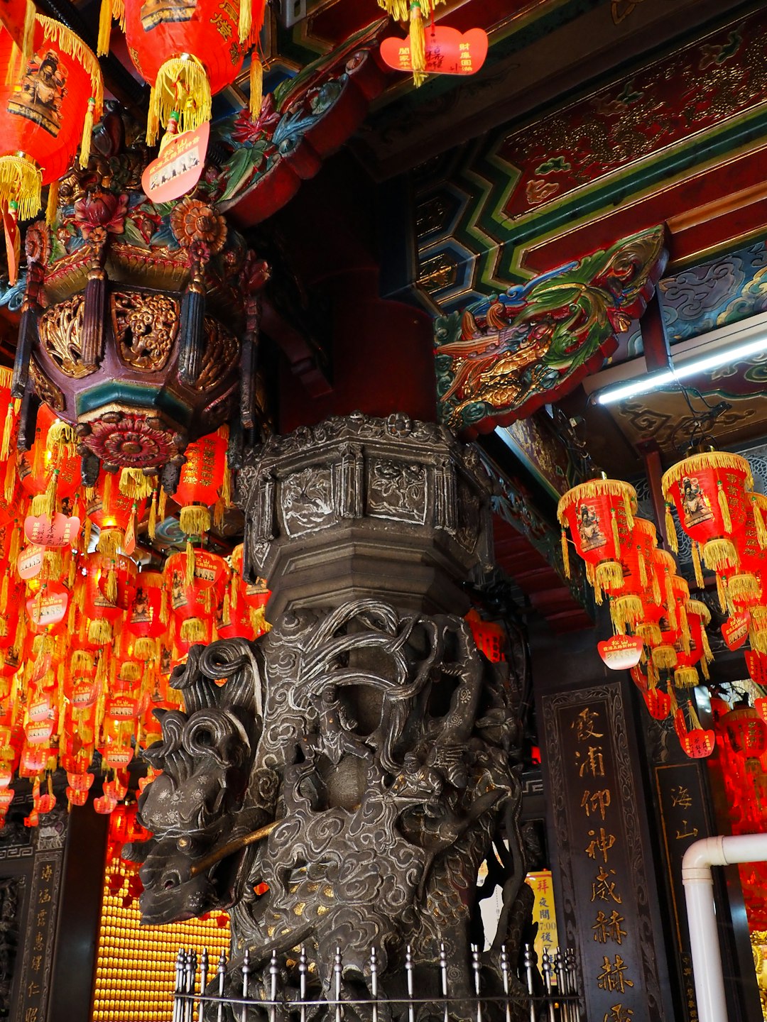a-statue-of-a-lion-surrounded-by-red-lanterns-wmhf1wgvdpw