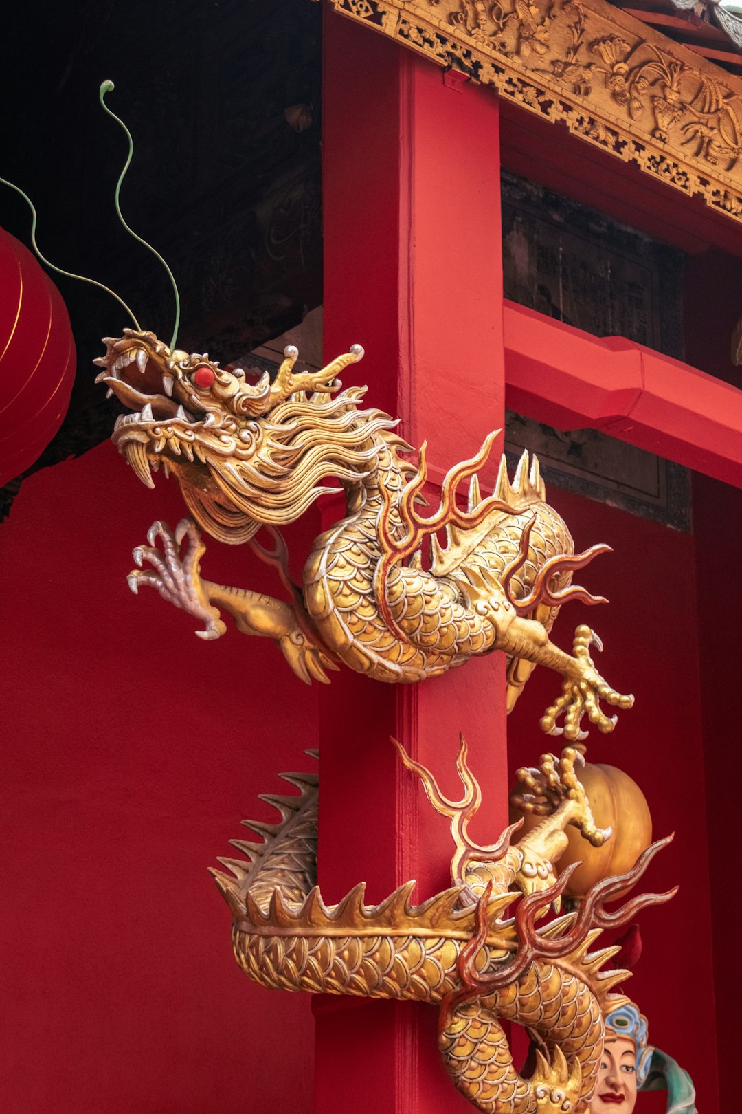 A Tall Red Building With Two Golden Dragon Statues On Its Side Vlokc5tsht4