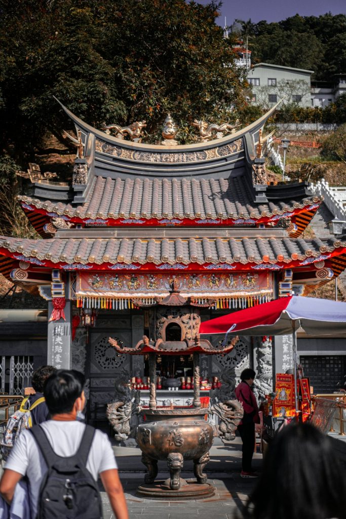 people-walking-on-red-and-white-chinese-temple-during-daytime-hr2hyrbzzwq